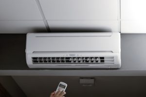 Hand controlling an air conditioner