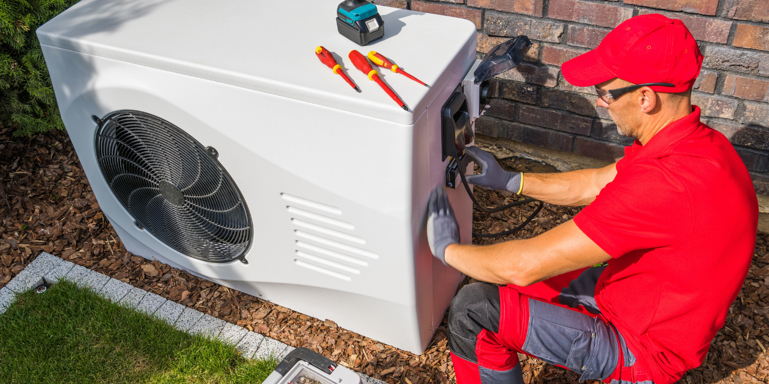 HVAC tech fixing Heat Pump - What is the Average Life Expectancy of a Heat Pump?