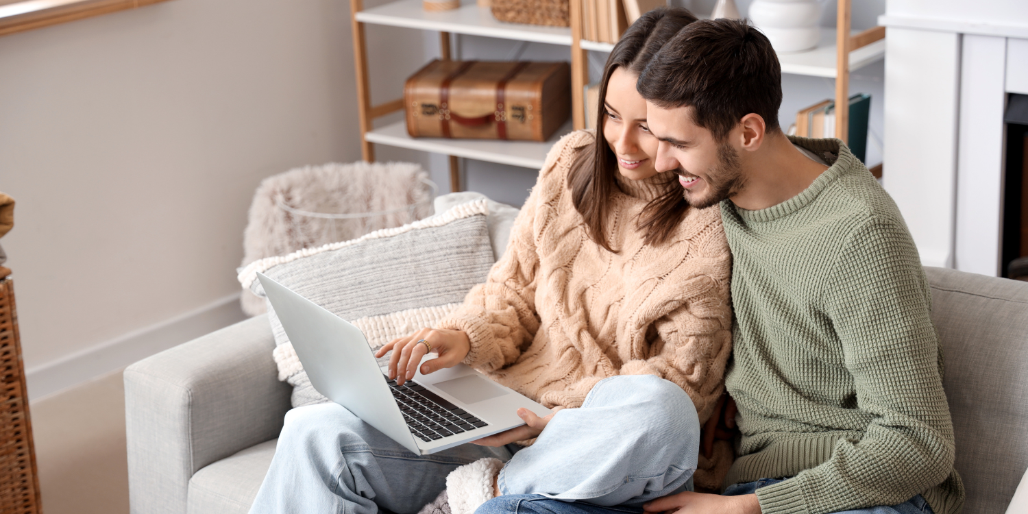 Young couple looking at computer together - Furnace Humidifiers and Better Indoor Air: Your Questions Answered 