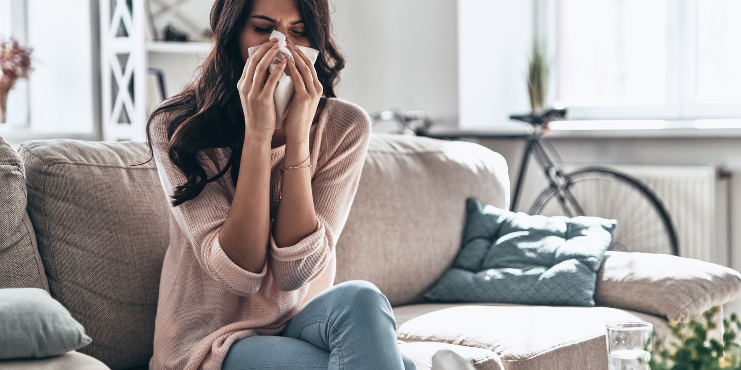 Lady at home sneezing due to allergies - Get Allergies at Home? Here are 3 Reasons a Whole-Home Humidifier Can Help  
